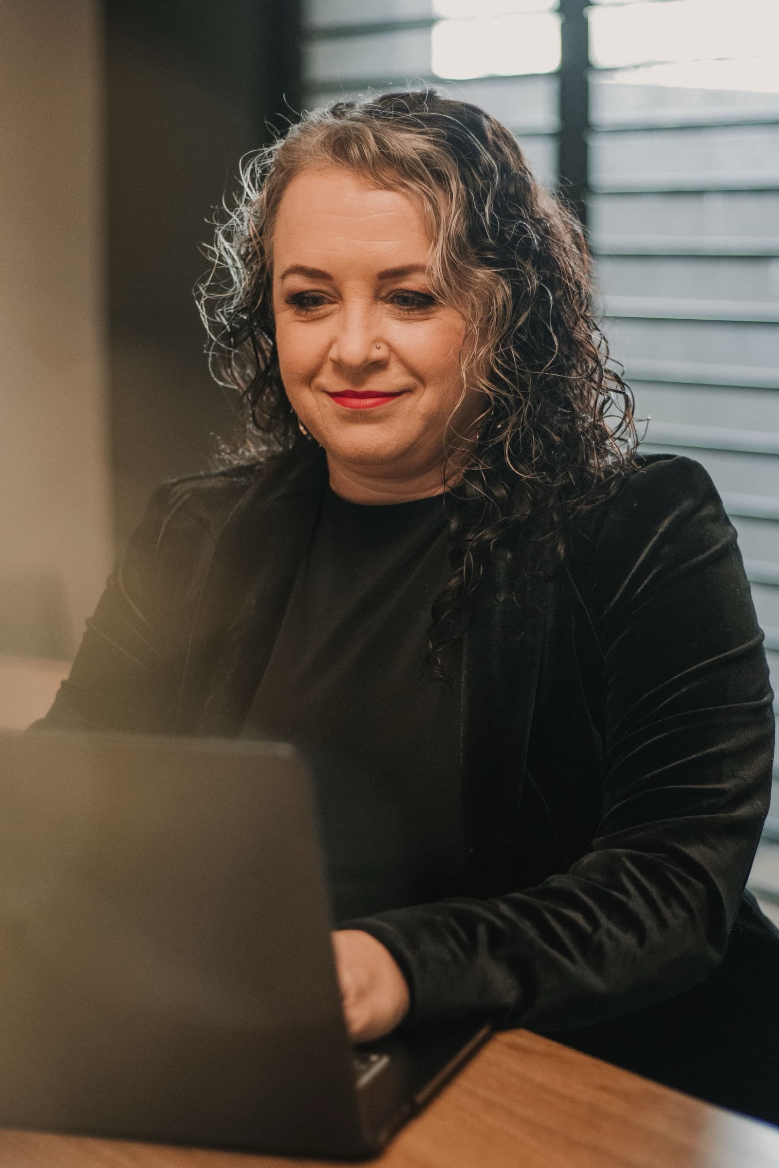 A property manager working calmly at a laptop